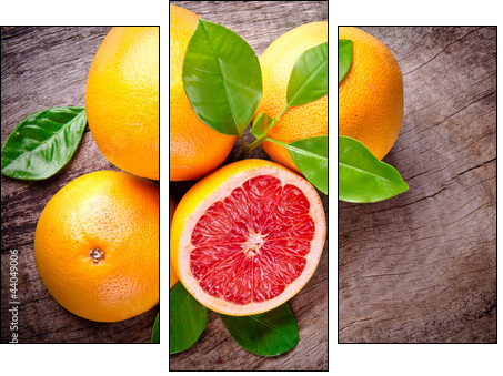 Freshly harvested grapefruit on wooden background - Three-piece canvas, Triptych